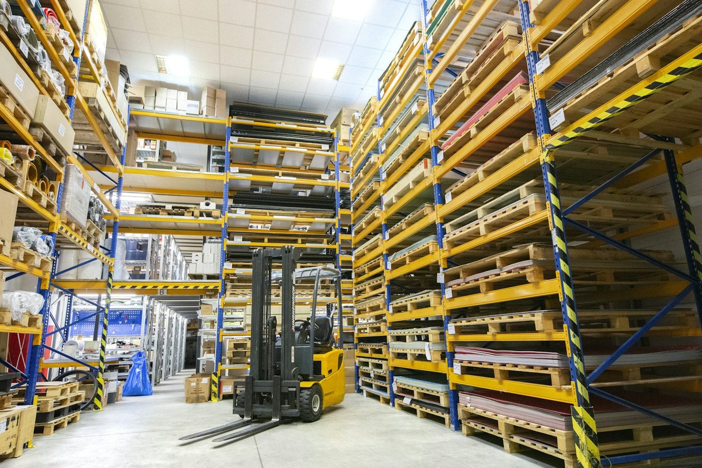 Warehouse team moving palletized freight with a forklift