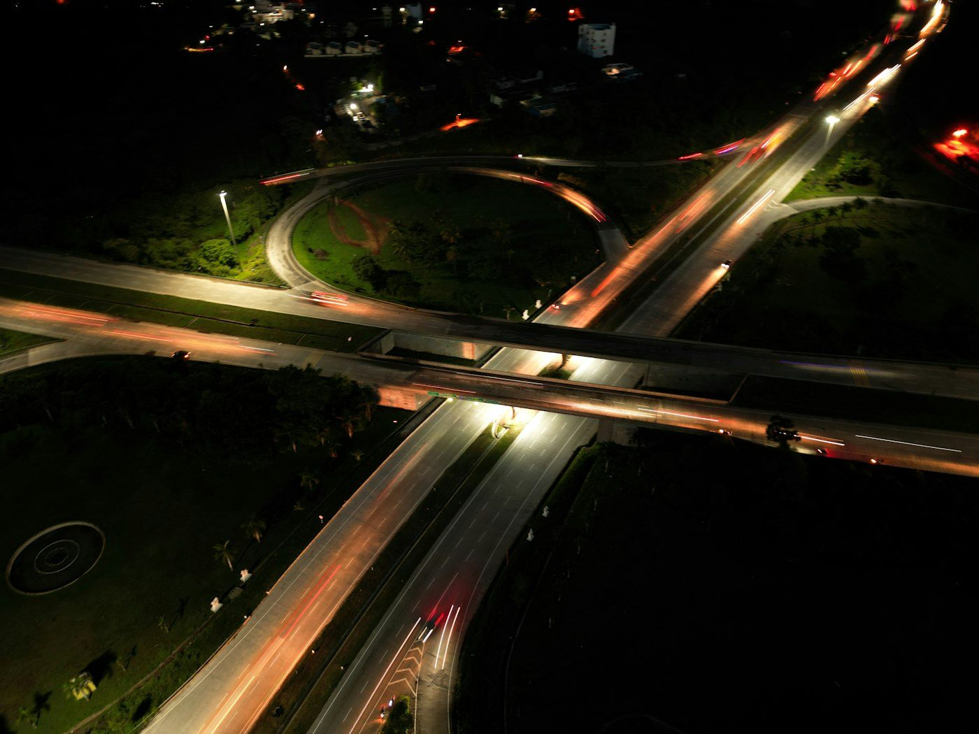 Aerial view of a highway interchange at night, representing a connected route network
