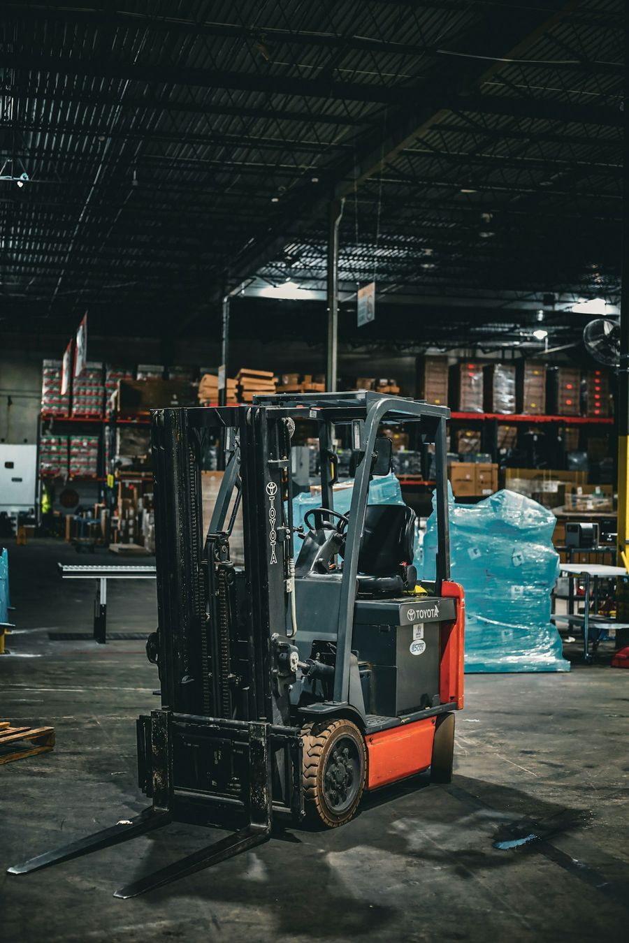 Forklift operating inside a large warehouse